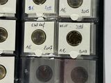 several different types of coins are in a plastic case