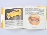 an open book with a picture of a yellow car and a picture of a red car