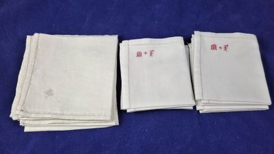 quatre serviettes blanches ornées d'inscriptions en chinois sur fond bleu