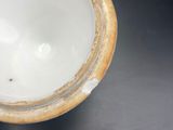 a close up of a vase on a black table