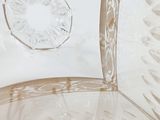 a close up of a clear glass bowl with a flower design on it