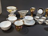 many cups and saucers sitting on a table