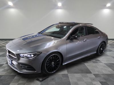 the mercedes cla is parked on a checkered floor in a garage