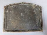 an old metal tray with a handle on a table