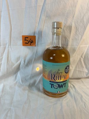 a bottle of rum that is sitting on a white sheet