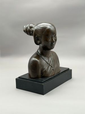 une image représentant une statue en bronze d'une femme posée sur un socle noir