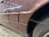a close up of a car that has a dent in the side of it
