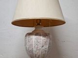 a lamp that is sitting on a table with a lamp shade on it