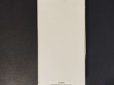 a white piece of paper sitting on top of a black table