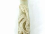 a white vase with a design on it on a white surface