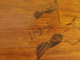 a drawing of two birds on a wooden table