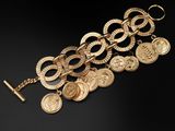 a close up of a bunch of gold coins on a black surface