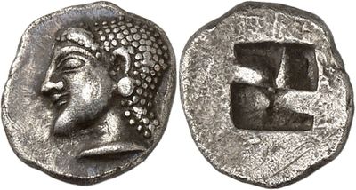 a silver coin with an image of a man ' s face on it