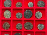 a lot of coins in a red tray on a table