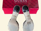 pair of black and white shoes sitting on top of a red box
