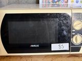 a microwave that is sitting on a counter top