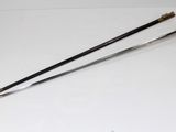 two swords are laying on a white surface next to each other