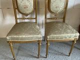pair of antique gold chairs with upholstered upholstered backs