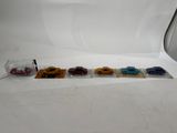 four toy cars are lined up in a row on a white surface