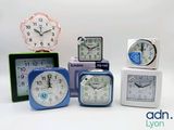 five different clocks sitting on top of each other