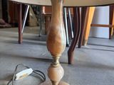 a lamp that is sitting on the floor next to a table