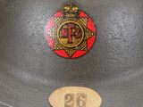 an old helmet with a badge on it sitting on top of a table