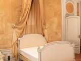 a bedroom with a bed, dresser, and a chair in it