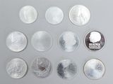 several coins are arranged in a row on a gray surface