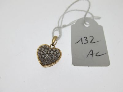 un gros plan d'un pendentif en forme de cœur sur lequel est accrochée une étiquette de prix