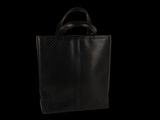 a black tote bag sitting on top of a black table