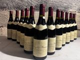 several bottles of wine are lined up in a row on a table