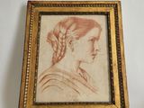 an old picture of a woman with braid hair in a gold frame