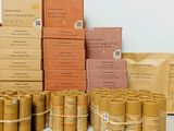 several boxes of various types of toilet paper are stacked on top of each other