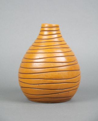 an image of a wooden vase on a gray surface