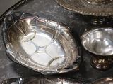 a silver tray with silver dishes and silver spoons on it