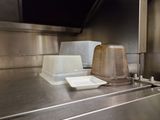 stainless steel counter top in a commercial kitchen with a plastic container on top of it