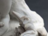 close up of a statue of a woman holding a child