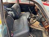 an old car with a leather seat and a steering wheel