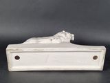 a white marble sculpture of a woman laying on a bed
