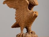 a statue of an eagle that is sitting on a rock