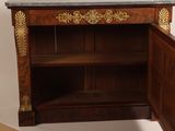 a wooden cabinet with a marble top and a door open