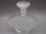 a clear glass bottle with a white lid on a table