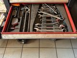 a drawer full of tools that is sitting on the floor