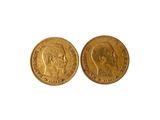 a close up of two gold coins on a white surface