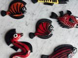 five different types of fish on a marble surface