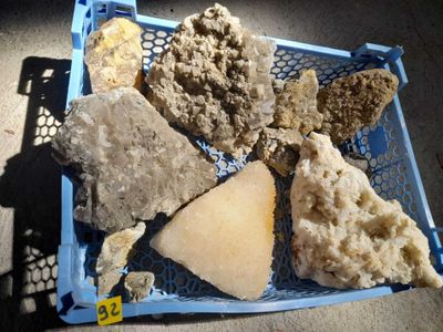 a blue basket filled with different types of rocks