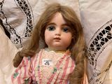 a doll that is laying down on a bed