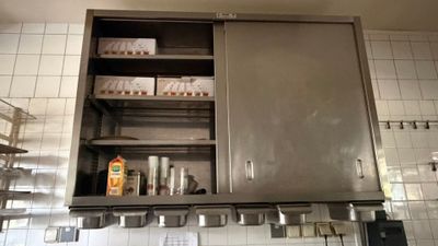 a large metal cabinet in the middle of a kitchen