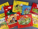 several children ' s books are lined up on a table