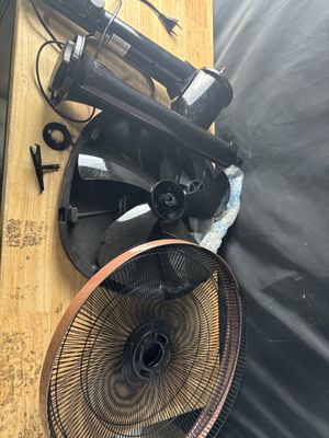 a picture of a table with a fan and other items on it